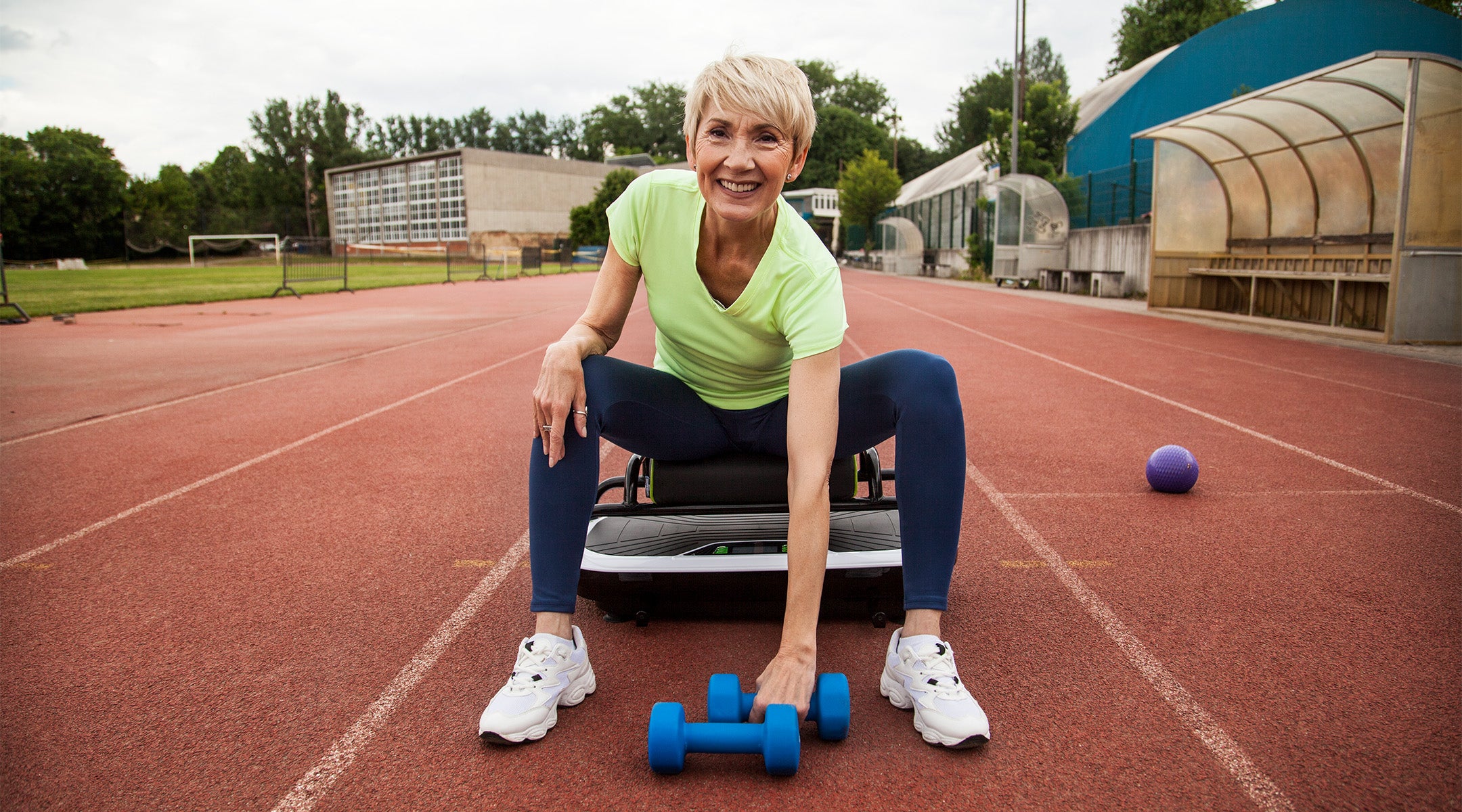 woman working out on donnerberg vibro plate with exercise seat outdoors
