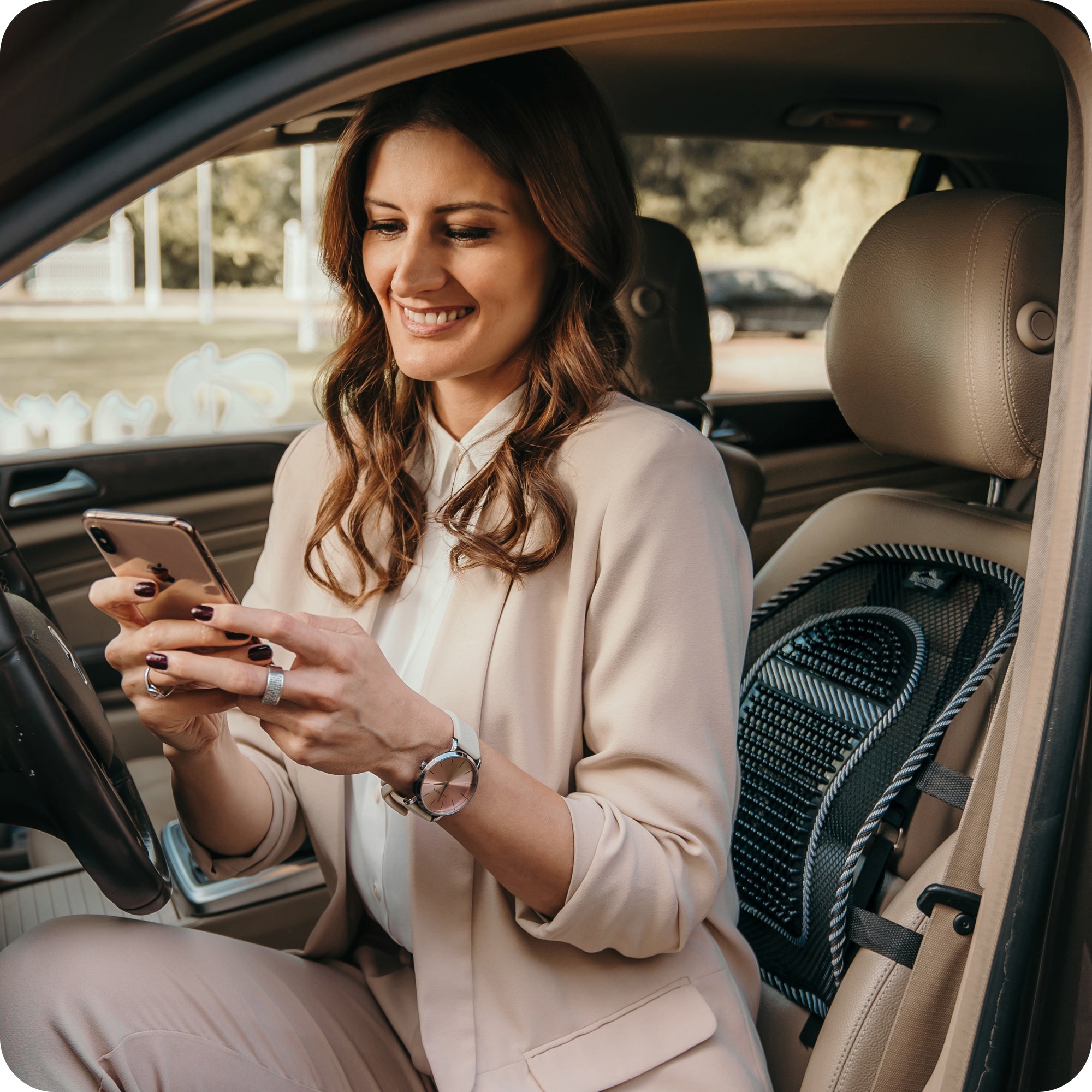 comfortable car ride: woman sitting with lumbar back support on seat