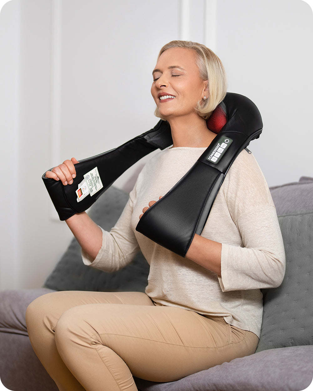 woman using neck massager at home to relieve pain