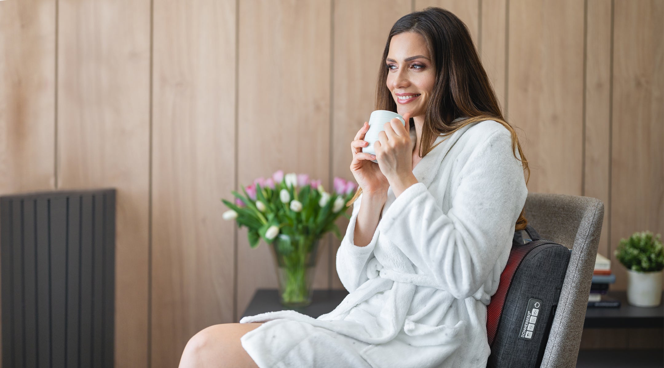 woman seated on chair experiencing relaxing back massage with massage cushion