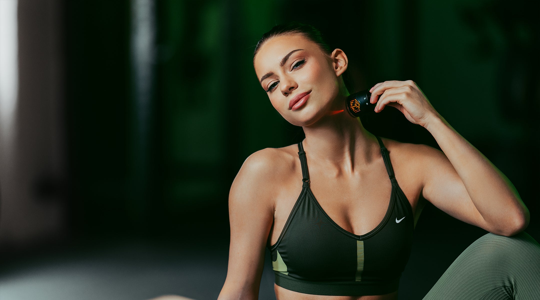 woman at gym using hot and cold attachment on neck to relax muscles
