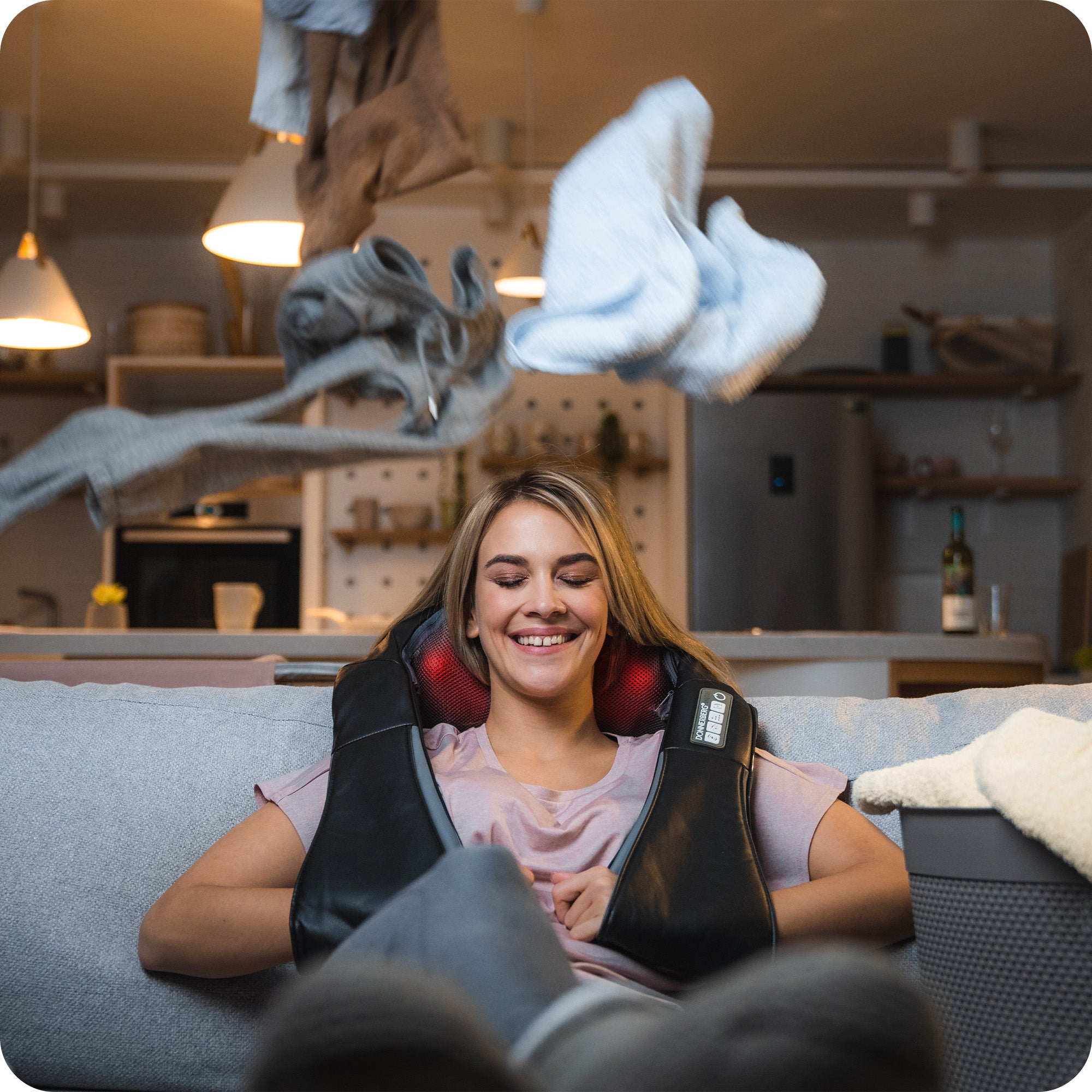 young woman enjoying Donnerberg shoulder massager while resting