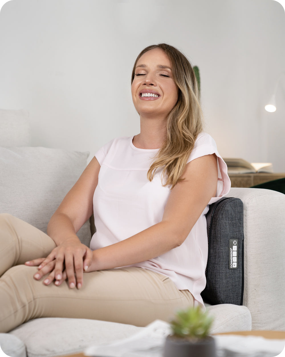 woman enjoying massage with back massager placed behind her back