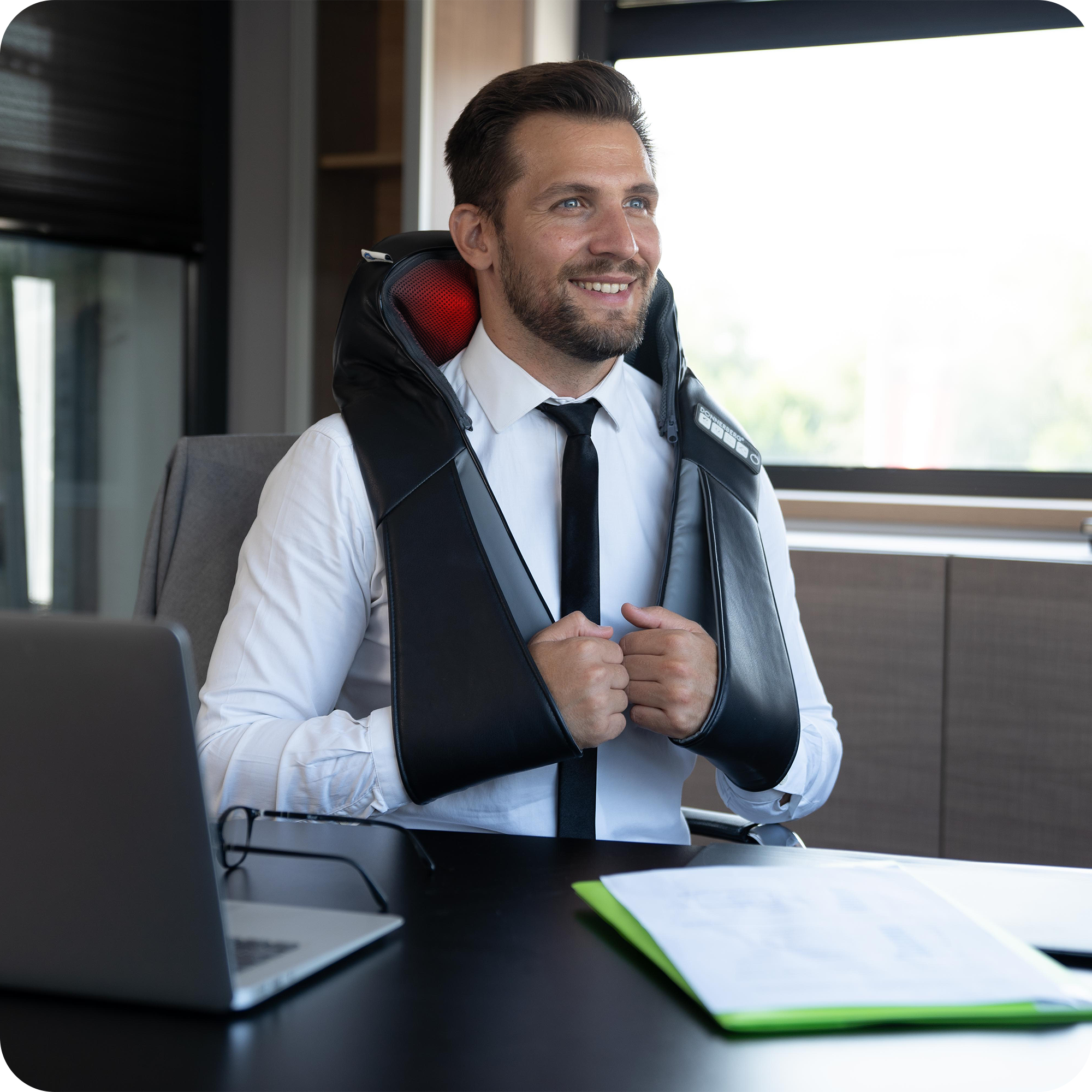 man using neck and back massager to relax in office