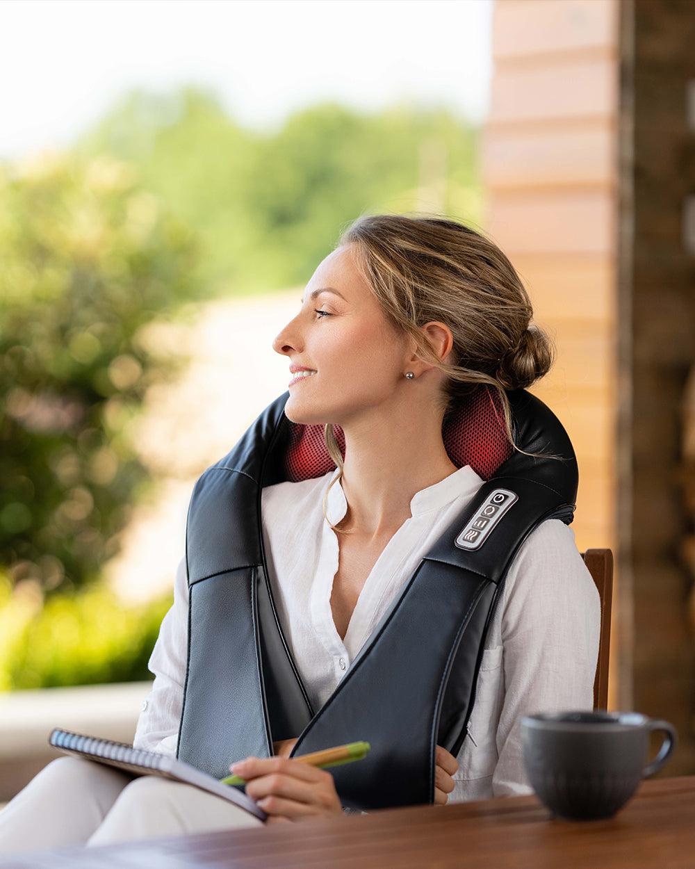 woman enjoying massage with electric neck massager