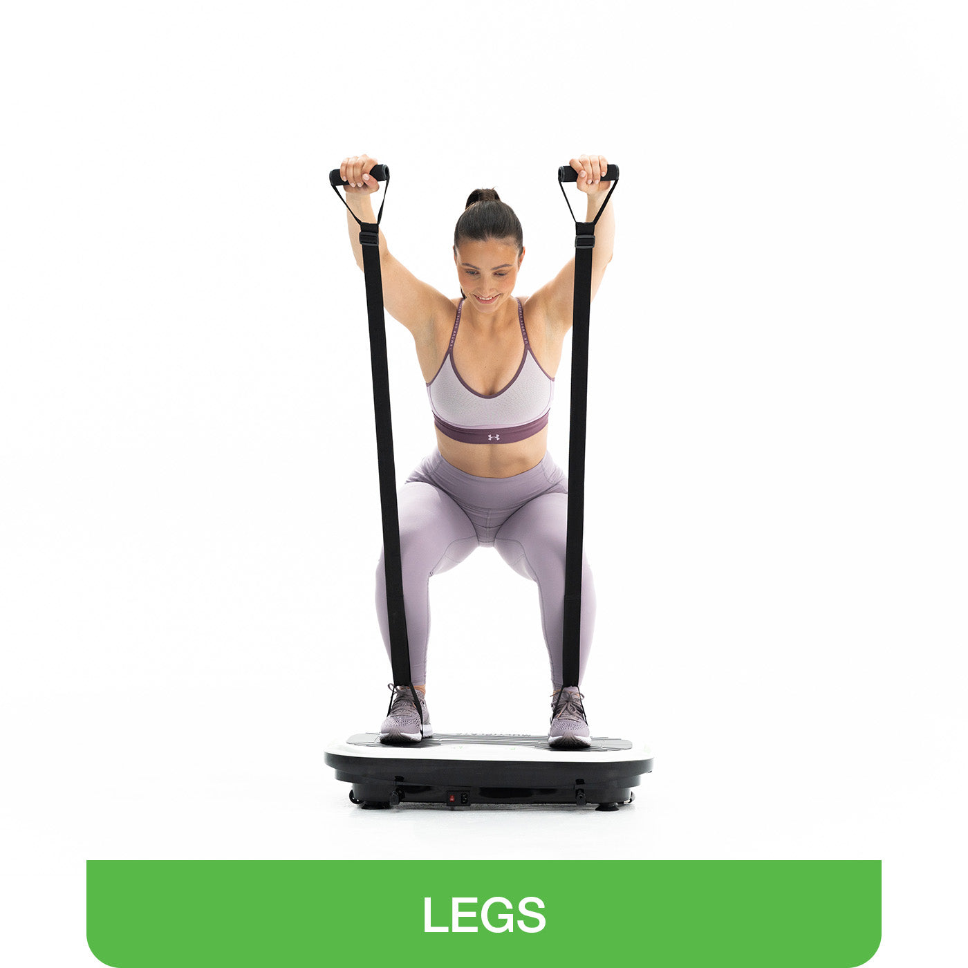woman on exercise plate doing squats with sling trainer