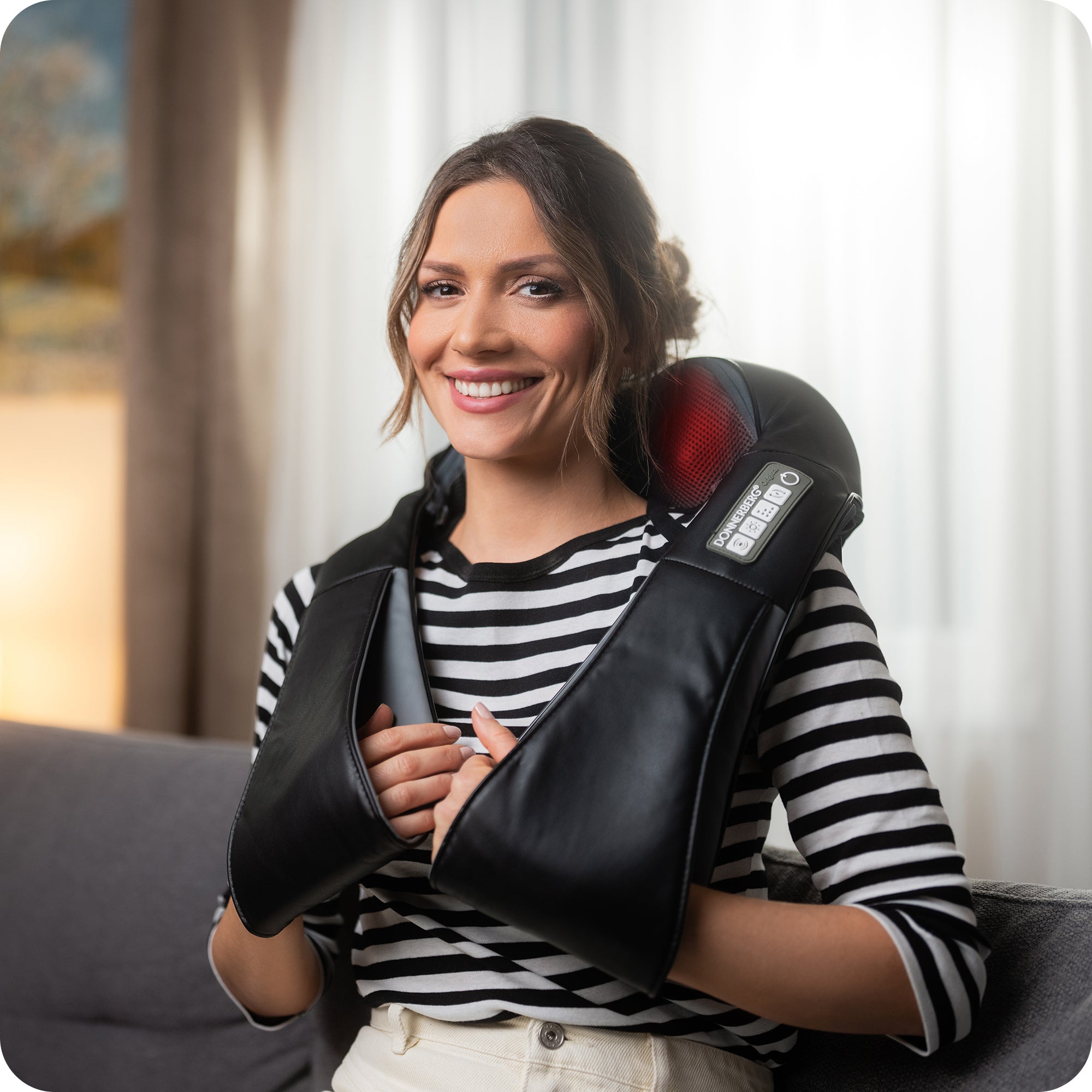 woman enjoying massage at home with shiatsu neck massager