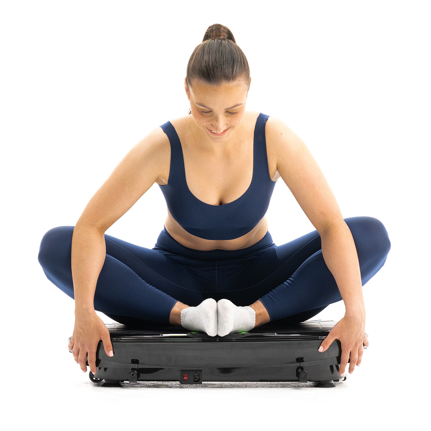 woman stretching on vibrating plate