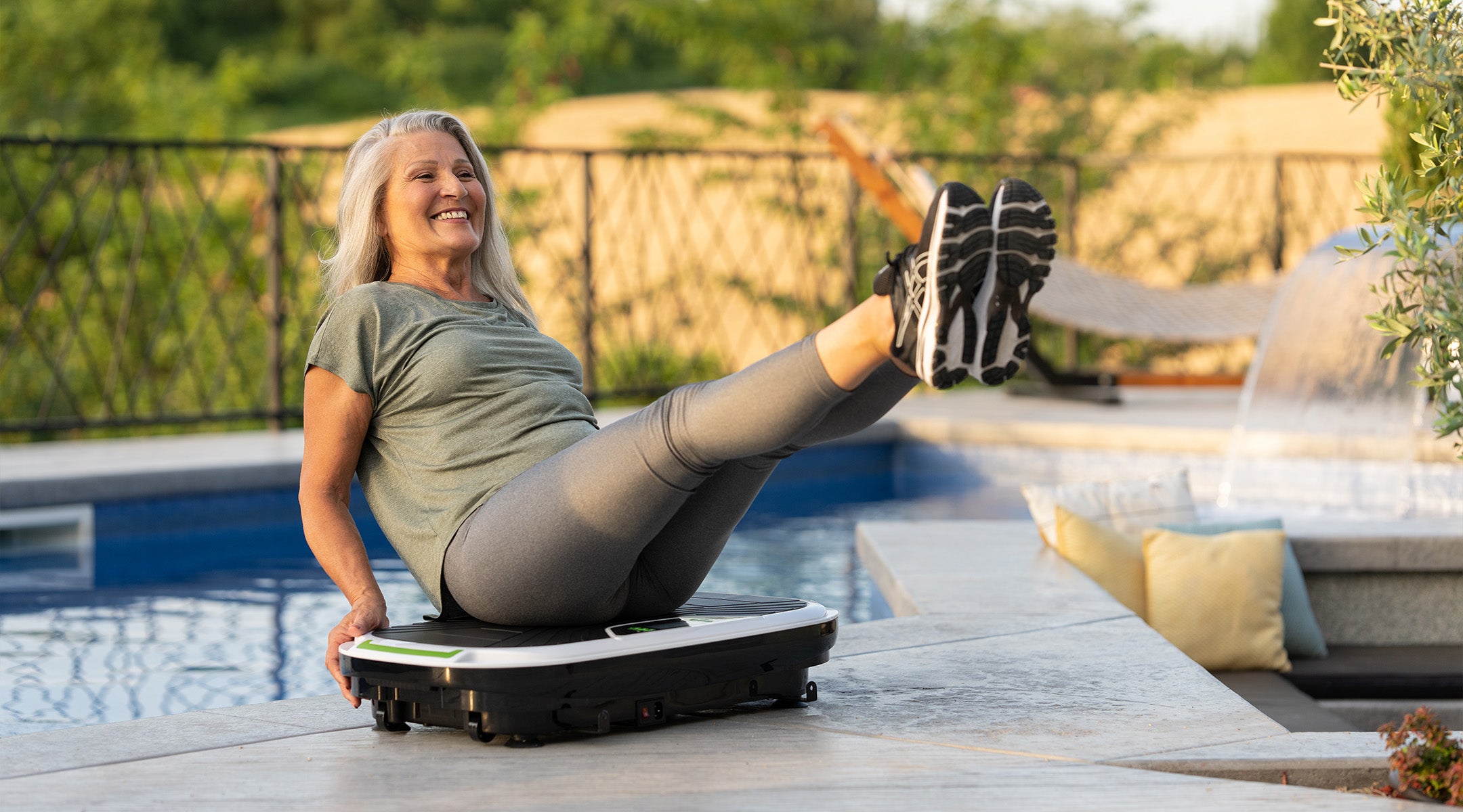 middle aged woman performing vibration training outdoors